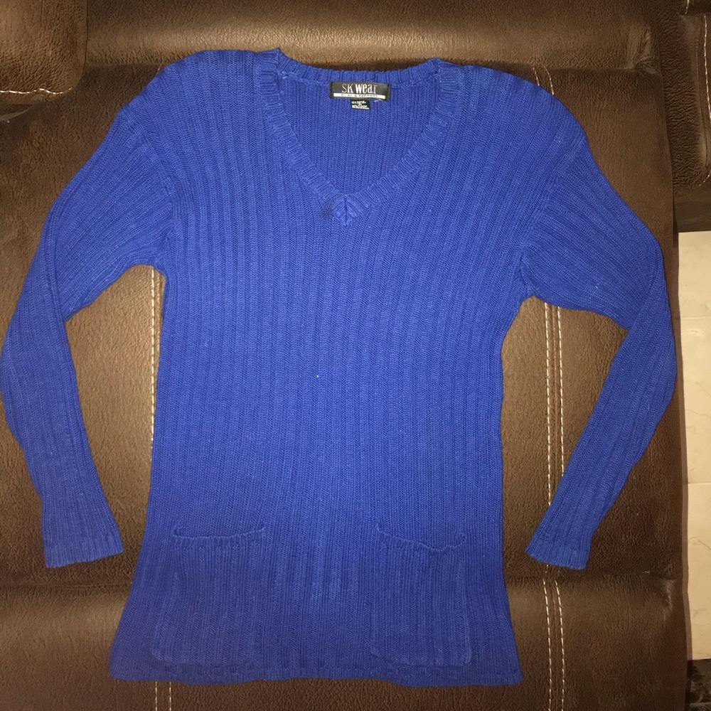 Blue sweater, with pockets.